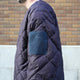 NANGA×MANUAL ALPHABET CMR REVERSE DOWN JACKET